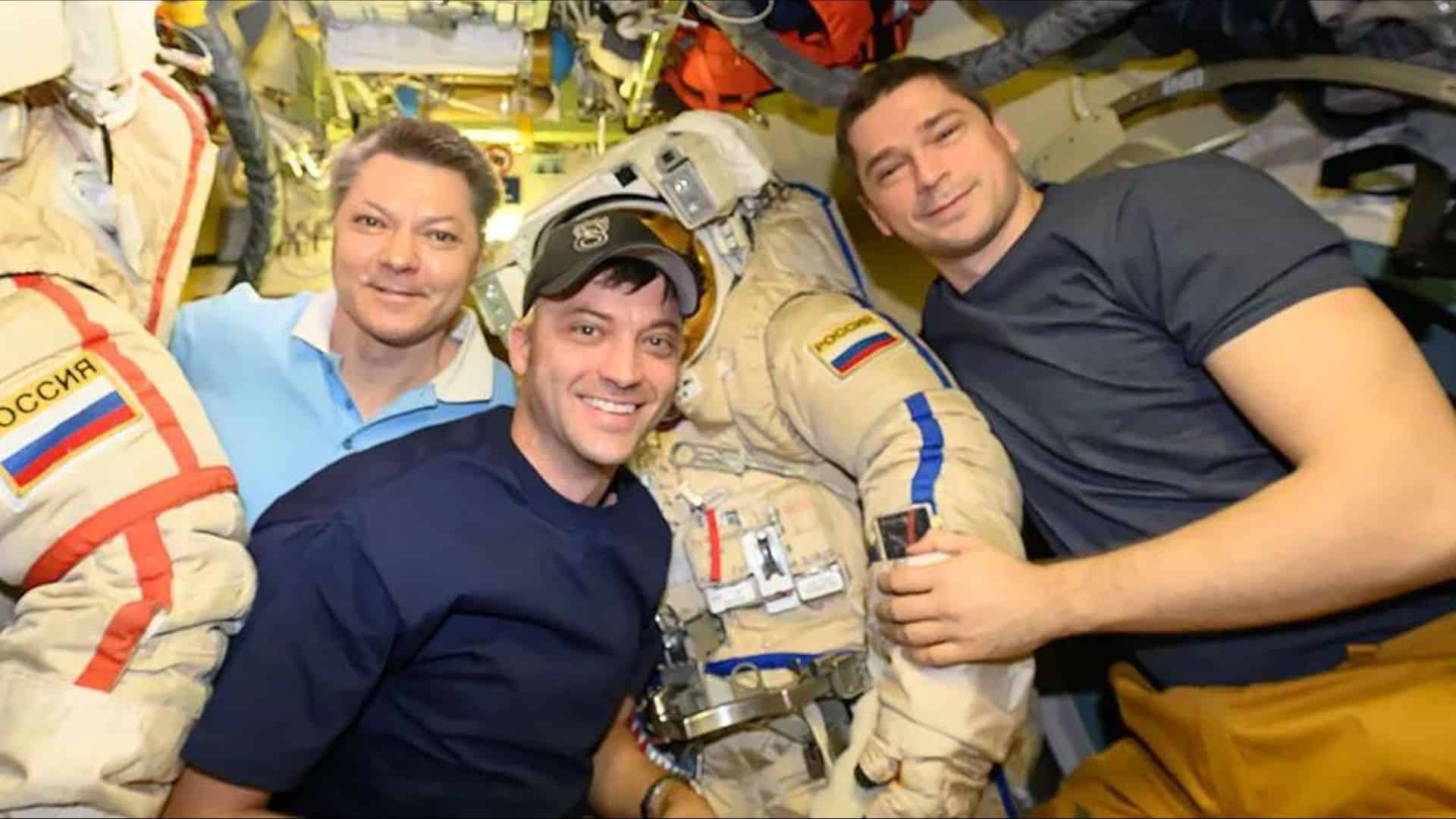 Astronaut Matthew Dominick (center) poses with cosmonauts Oleg Kononenko (left) and Nikolai Chub (right) while preparing Orlan spacesuits for a spacewalk