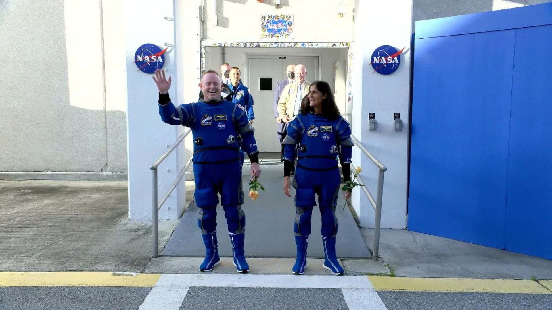 NASA astronauts Butch Wilmore and Suni Williams wave to family and friends before the Starliner launch